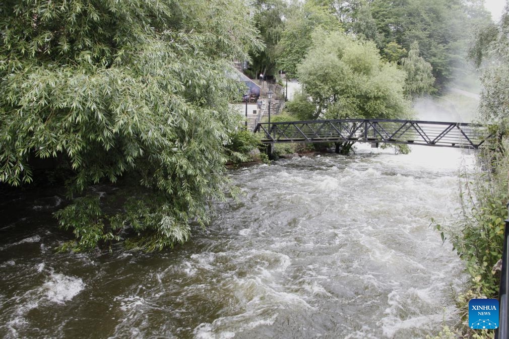 This photo taken on Aug. 10, 2023 shows water flooding down the Aker River in the downtown area of Oslo, capital of Norway. Storm Hans has been battering Norway since Monday, resulting in over 4,000 reports of damages to properties.(Photo: Xinhua)