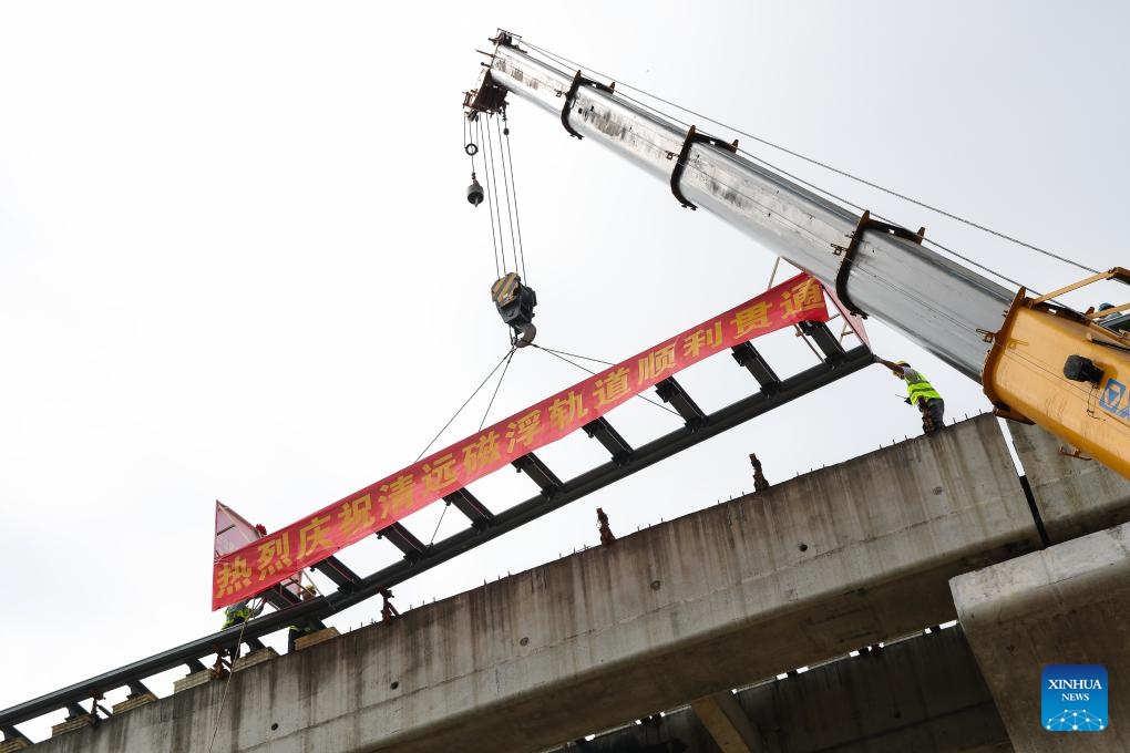 Workers lay the last 10-meter-long maglev track at the construction site of a medium-and-low speed maglev line in Qingyuan City, south China's Guangdong Province, Aug. 10, 2023. The last 10-meter-long maglev track was laid on the Qingyuan maglev tourism line on Thursday, marking the completion of the track-laying work for the first medium-and-low speed maglev line in the province.(Photo: Xinhua)