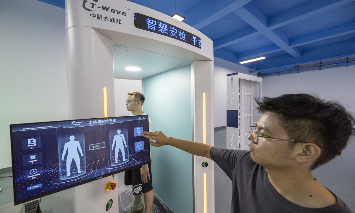 A technician scans a person through the company's self-developed terahertz body scanner on August 14, 2023 in Hefei, East China's Anhui Province. The Luyang Economic Development Zone in Hefei, where the company locates, aims to cultivate more specialized and sophisticated enterprises to produce new and unique products.  Photo:cnsphoto