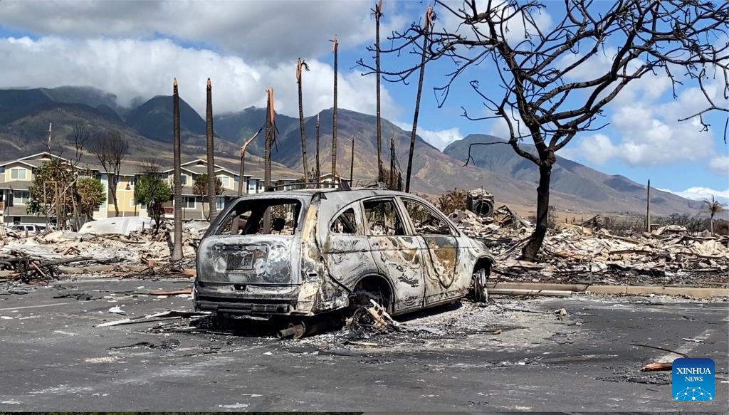 The photo taken with a mobile phone on Aug. 14, 2023 shows a vehicle destroyed in a wildfire in Lahaina town, Maui Island, Hawaii, the United States. The death toll from the Maui wildfires reached 99, authorities said Monday. Lahaina, a historic town on Maui Island, is facing a dire and immediate housing shortage and a serious threat of long-term displacement following the deadliest U.S. wildfire in over a century, reported The Washington Post on Monday.(Photo: Xinhua)