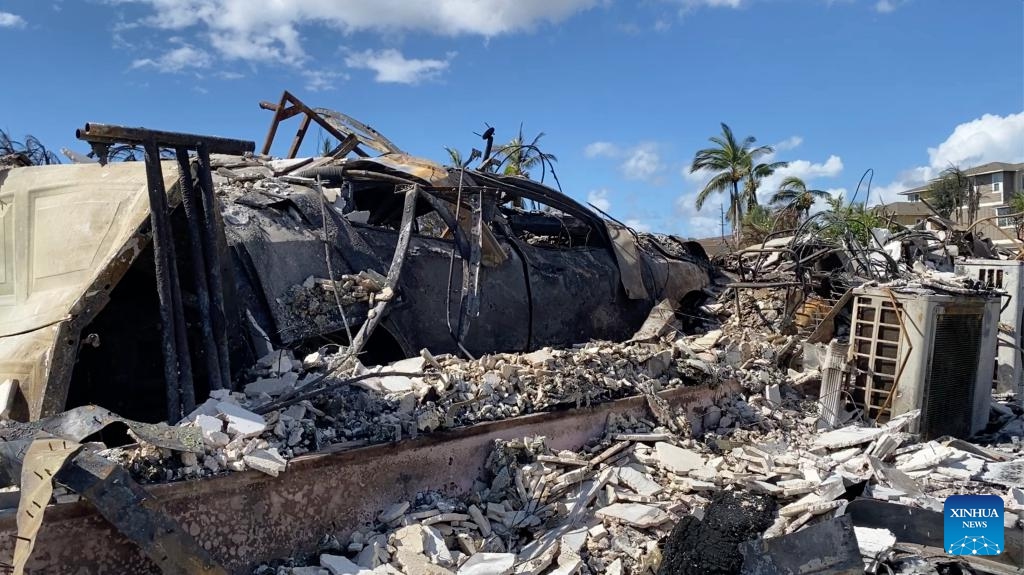 The photo taken with a mobile phone on Aug. 14, 2023 shows a vehicle destroyed in a wildfire in Lahaina town, Maui Island, Hawaii, the United States. The death toll from the Maui wildfires reached 99, authorities said Monday. Lahaina, a historic town on Maui Island, is facing a dire and immediate housing shortage and a serious threat of long-term displacement following the deadliest U.S. wildfire in over a century, reported The Washington Post on Monday. (Photo: Xinhua)