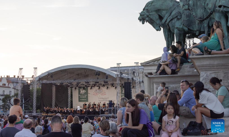 People listen to a free open air concert of the Budapest Festival Orchestra celebrating Budapest's 150th birthday on Heroes' square in Budapest, Hungary on Sept. 2, 2023. In 1873, Buda, Pest and Obuda were unified into one single city, naming the city Budapest. (Photo by Attila Volgyi/Xinhua)