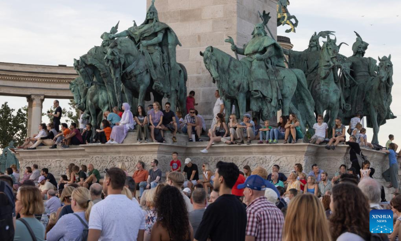 People listen to a free open air concert of the Budapest Festival Orchestra celebrating Budapest's 150th birthday on Heroes' square in Budapest, Hungary on Sept. 2, 2023. In 1873, Buda, Pest and Obuda were unified into one single city, naming the city Budapest. (Photo by Attila Volgyi/Xinhua)