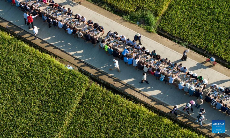 This aerial photo taken on Sept. 2, 2023 shows people taking part in a long-table banquet in Xinglong Village, Yanbian County of southwest China's Sichuan Province. (Xinhua/Jiang Hongjing)