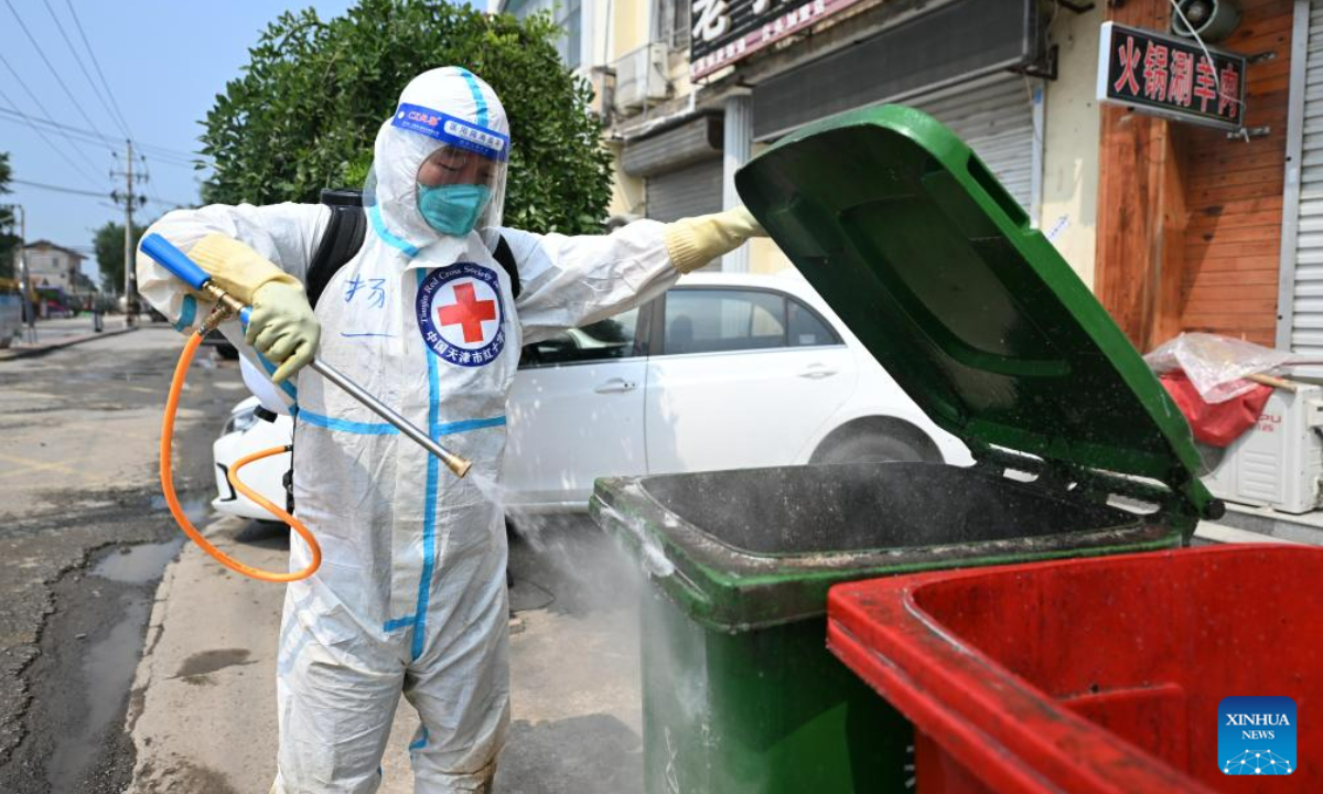 A staff member carries out disinfection at Taitou Town of Jinghai District, north China's Tianjin Municipality, Aug 17, 2023. Photo:Xinhua