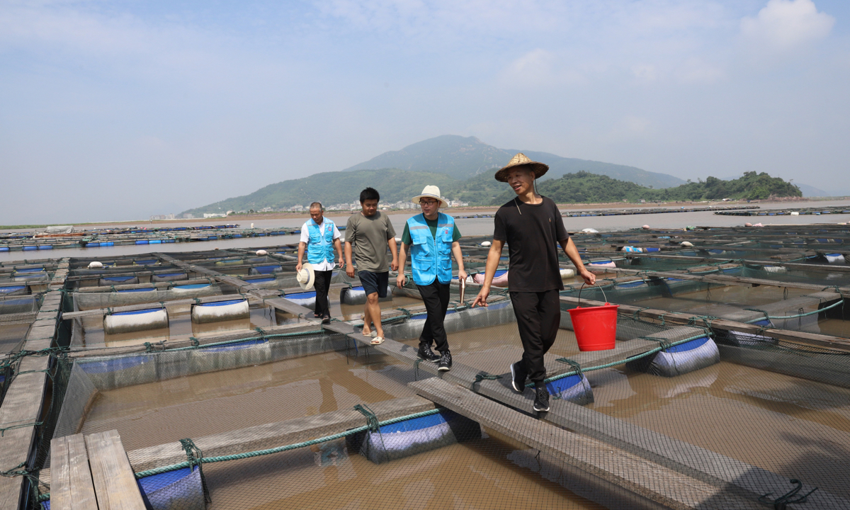 Workers patrol an aquaculture farm off the shore of East China’s Zhejiang Province on August 22, 2023. In 2022, the province produced 1.52 million tons of aquaculture products from the sea, up 9 percent year-on-year. 