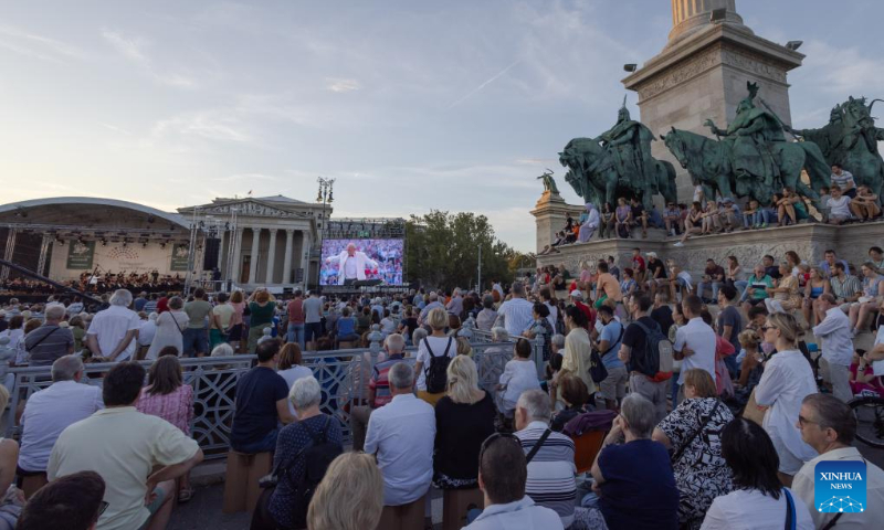 People listen to a free open air concert of the Budapest Festival Orchestra celebrating Budapest's 150th birthday on Heroes' square in Budapest, Hungary on Sept. 2, 2023. In 1873, Buda, Pest and Obuda were unified into one single city, naming the city Budapest. (Photo by Attila Volgyi/Xinhua)