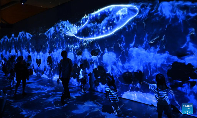 People interacts with virtual marine organisms at a whale-themed exhibition of National Maritime Museum of China in north China's Tianjin Municipality, Aug. 26, 2023. (Xinhua/Sun Fanyue)