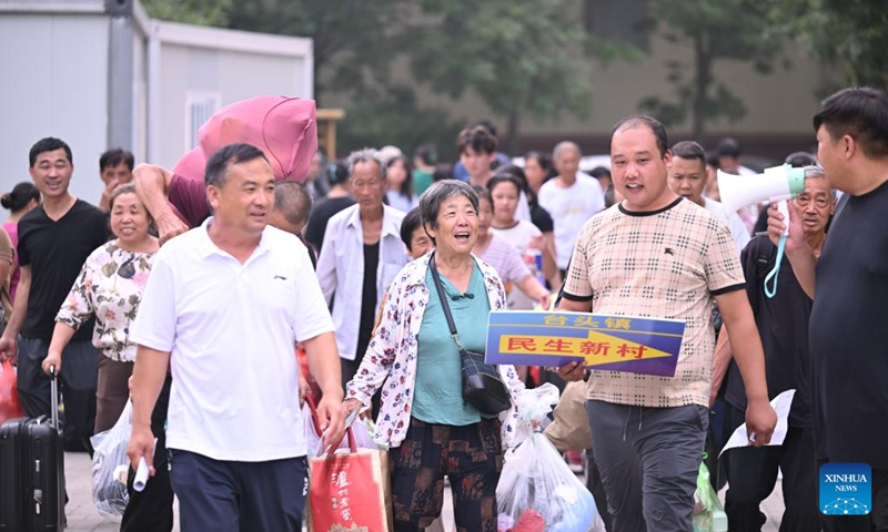 Villagers get their personal belongings and prepare to go home from a relocation site in Xiqing District, north China's Tianjin Municipality, Aug. 20, 2023. All of over 37,000 relocated villagers from the Dongdian flood storage and retention area in Jinghai District of north China's Tianjin have returned to their homes as floodwater receded. Photo: Xinhua