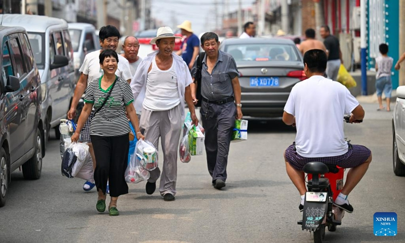 Villagers greet each other as they are back home in Taitou Town of Jinghai District, north China's Tianjin Municipality, Aug. 20, 2023. All of over 37,000 relocated villagers from the Dongdian flood storage and retention area in Jinghai District of north China's Tianjin have returned to their homes as floodwater receded. Photo: Xinhua