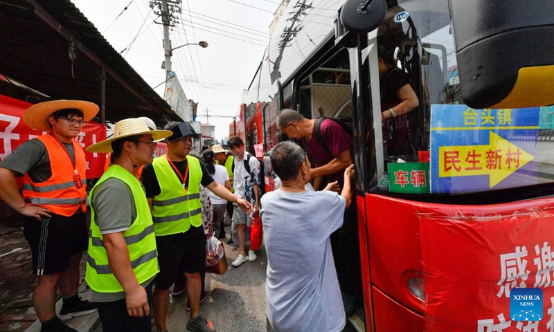 Villagers come back home in buses in Taitou Town of Jinghai District, north China's Tianjin Municipality, Aug. 20, 2023. All of over 37,000 relocated villagers from the Dongdian flood storage and retention area in Jinghai District of north China's Tianjin have returned to their homes as floodwater receded. Photo: Xinhua