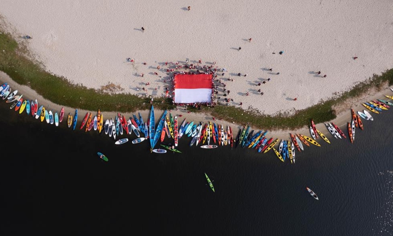 This aerial photo taken on Aug. 17, 2023 shows people unfurling the national flag of Indonesia during the 78th Independence Day celebration in Jakarta, Indonesia.(Photo: Xinhua)