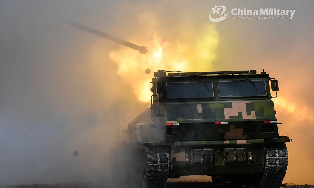 A vehicle-mounted multiple launch rocket system (MLRS) attached to an artillery element of an army brigade fires at mock target during a round-the-clock training exercise held in recent days. (eng.chinamil.com.cn/Photo by Liu Zhiyong)