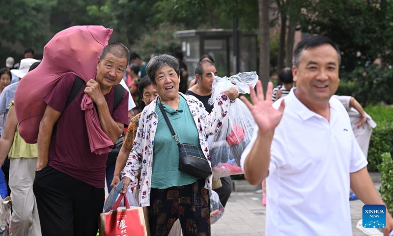 Villagers get their personal belongings and prepare to go home from a relocation site in Xiqing District, north China's Tianjin Municipality, Aug. 20, 2023. All of over 37,000 relocated villagers from the Dongdian flood storage and retention area in Jinghai District of north China's Tianjin have returned to their homes as floodwater receded. Photo: Xinhua