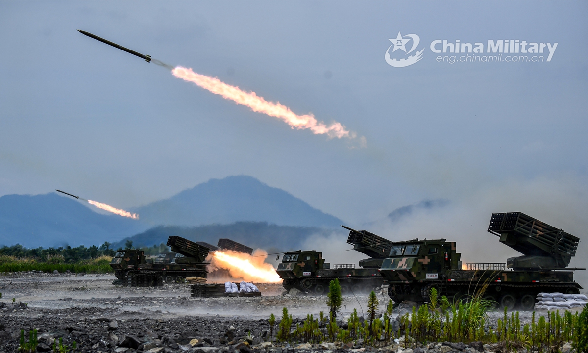 Vehicle-mounted multiple launch rocket systems attached to an artillery element of an army brigade fire at mock targets during a round-the-clock training exercise held in recent days. (eng.chinamil.com.cn/Photo by Liu Zhiyong)