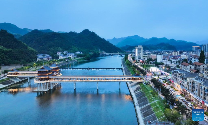 This aerial photo taken on Aug. 18, 2023 shows a view of Changhua river in Changhua Town of Hangzhou City, east China's Zhejiang Province. The cultural festival, which kicked off Friday in Changhua Town, aimed to boost the nighttime economy by presenting the culture of Tang (618-907) and Song (960-1279) Dynasties and promoting local snacks and scenic spots. (Xinhua/Xu Yu)