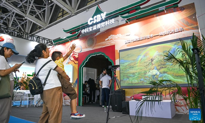 Visitors experience digital display technology in the digital culture exhibition area at the 10th West China Culture Industries Expo in Xi'an, northwest China's Shaanxi Province, Aug. 18, 2023. The 10th West China Culture Industries Expo opened on Thursday in Xi'an and will last till Aug. 20. The digital culture exhibition area of the expo features the latest achievements in the application of digital technology in the cultural industry, providing immersive experience of digital culture for the visitors.  Photo: Xinhua