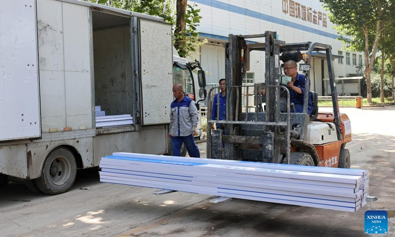 Workers prepare to load products onto a truck at a building materials company in Zhuozhou City, north China's Hebei Province, Aug. 19, 2023. At present, the post-disaster recovery and reconstruction work is intensively carried out in Zhuozhou City. The local government has been speeding up the repair of infrastructure and assisting enterprises to resume production. (Xinhua/Luo Xuefeng)