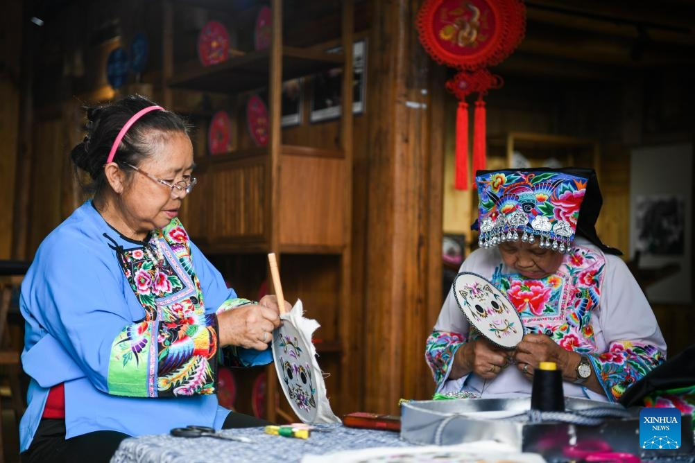 Villagers make embroidery of the Miao ethnic group in Huatian Township, Youyang Tujia and Miao Autonomous County, southwest China's Chongqing Municipality, on Aug. 20, 2023. Youyang, one of the key beneficiary counties of state assistance for rural revitalization, has been fully availing of its unique advantages in ecological environment and indigenous tradition to promote converged development of agriculture, culture, and tourism.(Photo: Xinhua)