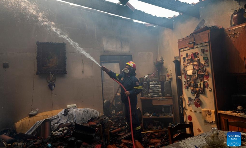 A firefighter tries to extinguish a wildfire in Hasia village, near Athens, Greece, on Aug. 22, 2023. Wildfires, erupted on Tuesday near the Greek capital, forced the evacuation of settlements and the closure of roads.(Photo: Xinhua)