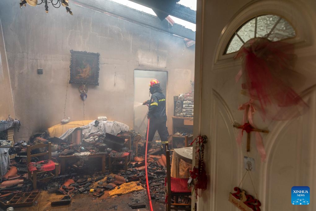 A firefighter tries to extinguish a wildfire in Hasia village, near Athens, Greece, on Aug. 22, 2023. Wildfires, erupted on Tuesday near the Greek capital, forced the evacuation of settlements and the closure of roads.(Photo: Xinhua)