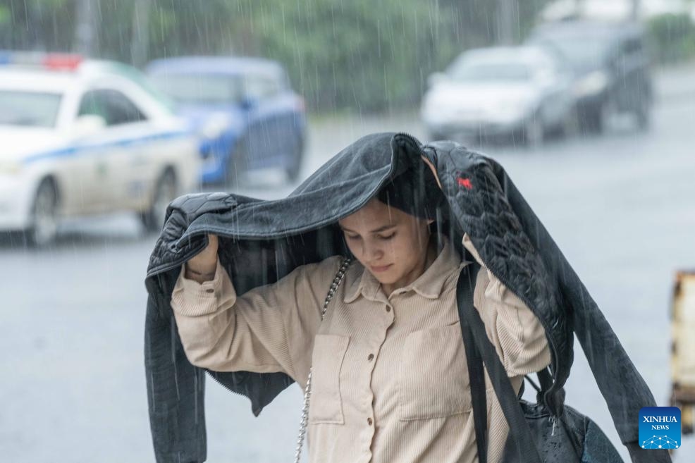 A woman walks in the rain in downtown Vladivostok, Russia, Aug. 23, 2023. The city experienced torrential rain on Wednesday, causing flooding in low-lying areas of the urban area.(Photo: Xinhua)