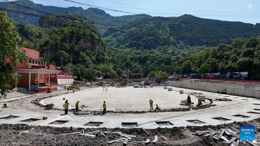 This aerial photo taken on Aug. 23, 2023 shows construction workers on the playground at the Xiayunling central primary school in Fangshan District of Beijing, capital of China. Due to the influence of heavy rainfall, Xiayunling central primary school in Fangshan District of Beijing had part of its buildings and playground collapsed, and the road and bridge in front of the school damaged.(Photo: Xinhua)