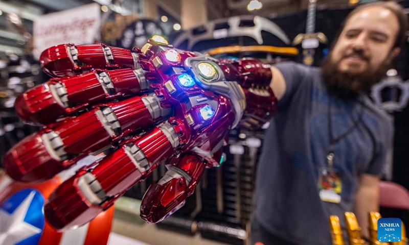 An exhibitor shows an iron man infinity gauntlet during the 2023 Fan Expo Canada in Toronto, Canada, on Aug. 25, 2023. As one of the largest comics, sci-fi, anime and gaming events in Canada, the annual event is held here from Aug. 24 to Aug. 27, attracting hundreds of thousands of fans from across the world. Photo: Xinhua