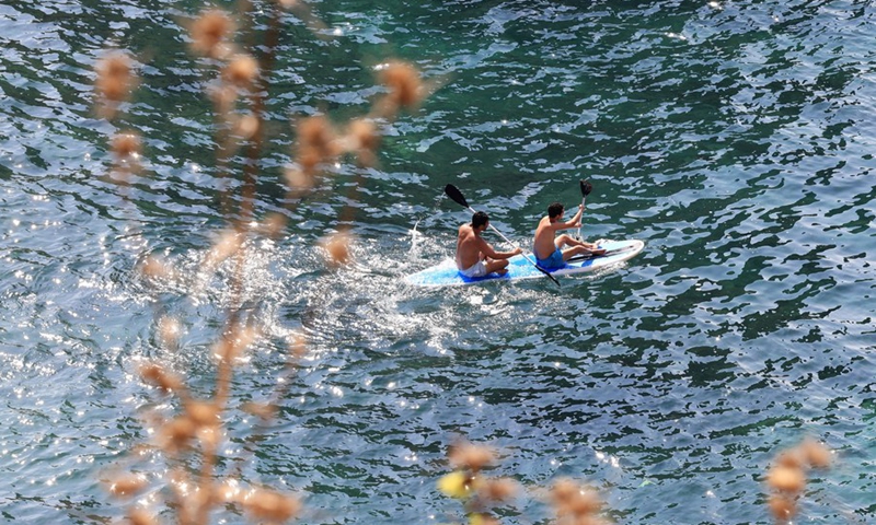 Tourists go canoeing near the Pigeon Rocks in Beirut, Lebanon, on Aug. 23, 2023. Photo: Xinhua