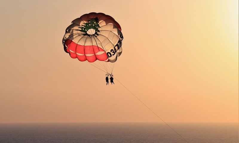 Tourists paraglide along the coast of Beirut, Lebanon, on July 19, 2023. Photo: Xinhua