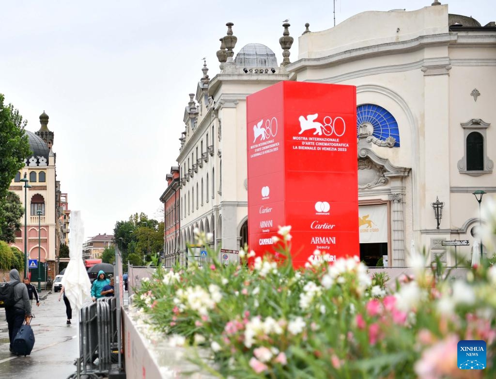 People walk past signs of the 80th Venice International Film Festival in Venice, Italy, on Aug. 29, 2023. The 80th Venice International Film Festival will kick off here on Aug. 30.(Photo: Xinhua)