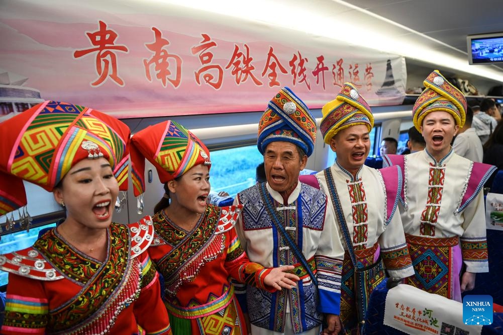 People in traditional ethnic attire sing on Fuxing bullet train G4308 running from Nanning to Guiyang Aug. 31, 2023. The 482-kilometer Guiyang-Nanning high-speed railway, linking Guiyang, capital of southwest China's Guizhou Province, and Nanning, capital of south China's Guangxi Zhuang Autonomous Region, launched its full-scale services on Thursday.(Photo: Xinhua)