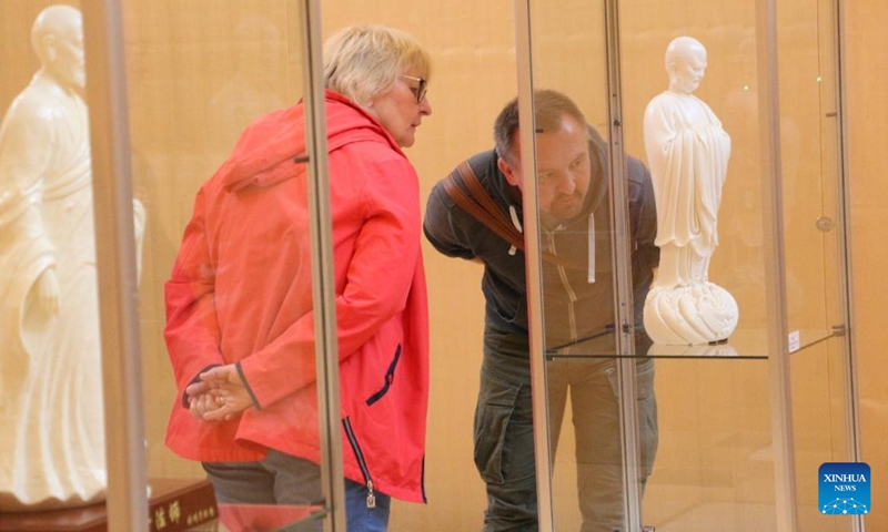 Visitors view exhibits during an itinerant exhibition of Chinese Dehua white porcelain in Frankfurt, Germany, Aug. 29, 2023. An exhibition of the famous Chinese Dehua white porcelain is in full swing at the Stadthaus in Frankfurt, Germany. Over 90 items of Dehua white porcelain, known to European customers as Blanc de Chine, are on display at the exhibition.(Photo: Xinhua)