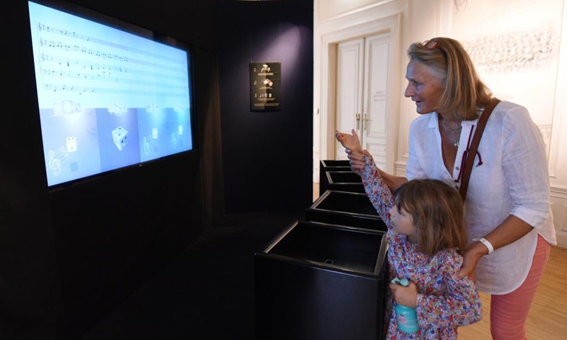 Visitors compose music by throwing the virtual dice at House of Music in Vienna, Austria, on Sept. 2, 2023. House of Music is an interactive sound museum located in Vienna, to provide a playful approach to understand music. Photo: Xinhua