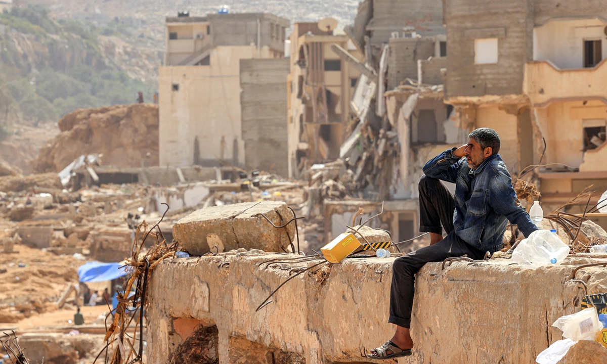 A man surveys the damage caused by deadly flash floods from the rubble of a destroyed building in Libya's eastern city of Derna, on September 18, 2023. Photo: VCG