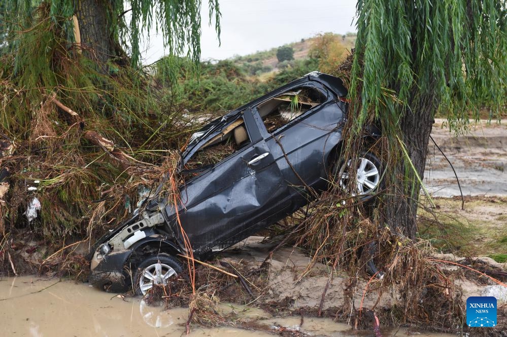 A broken vehicle is seen after storms in Villamanta of Madrid, Spain, Sept. 4, 2023. Spain's State Meteorological Agency (AEMET) has declared a red alert for extreme weather and heavy rainfall in central and eastern Spain on Sunday.(Photo: Xinhua)