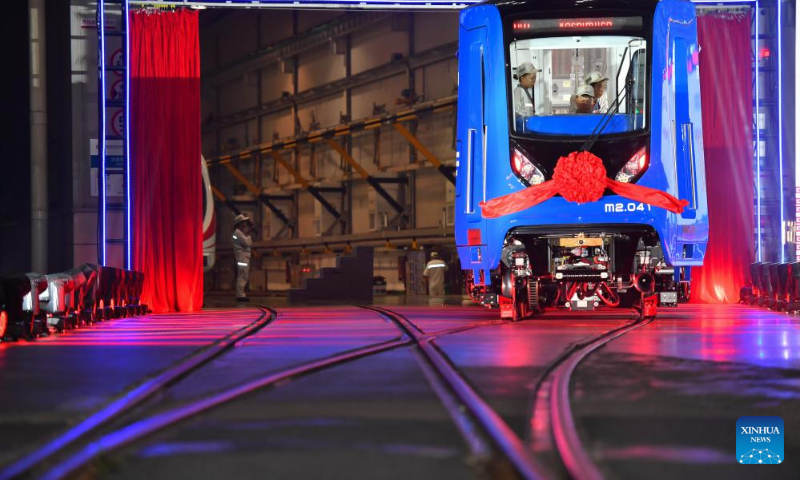 Workers inspect the first articulated light rail train customized by CRRC Zhuzhou Locomotive Co., Ltd. for Mexico City, in Zhuzhou, central China's Hunan Province, Sept. 9, 2023. The first articulated light rail train customized by CRRC Zhuzhou Locomotive Co., Ltd. for Mexico City has rolled off the assembly line on Saturday. (Xinhua/Chen Zeguo)