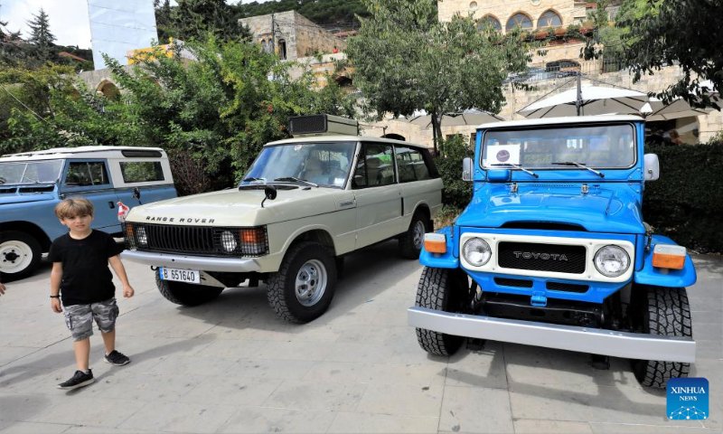 A boy visits a classic car show held in Deir el Qamar, Mount Lebanon Governorate, Lebanon, on Sept. 10, 2023. A classic car show was held Sunday in Deir el Qamar, a historic town in south-central Lebanon, featuring about 50 classic cars from different eras. (Xinhua/Liu Zongya)