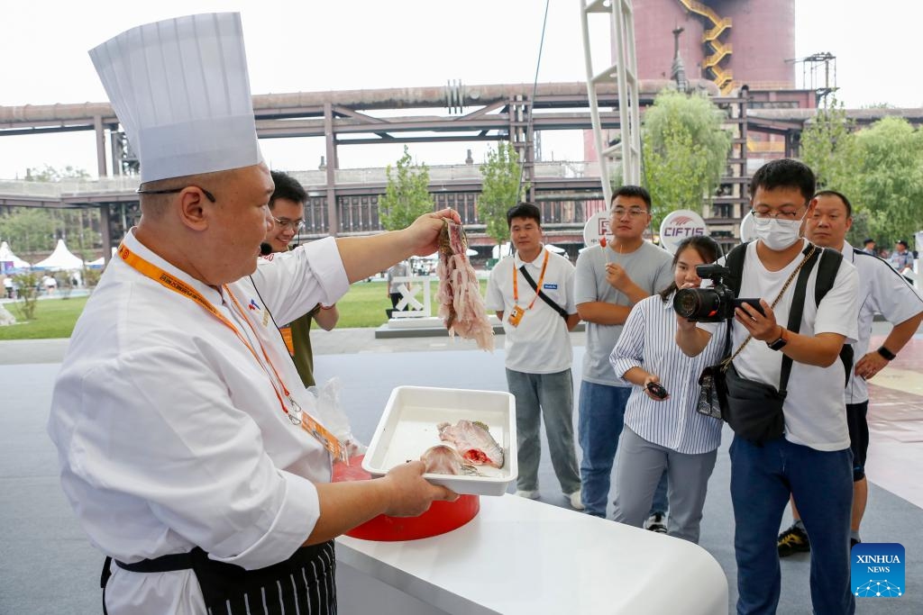 A chef demonstrates knife-handling skills at the exhibition hall of Beijing time-honored brand during the 2023 China International Fair for Trade in Services (CIFTIS) in Beijing, capital of China, Sept. 2, 2023. A number of time-honored brands in catering business made their debut at the exhibition hall of Beijing time-honored brand during the 2023 CIFTIS, attracting numerous guests to come for a taste.(Photo: Xinhua)