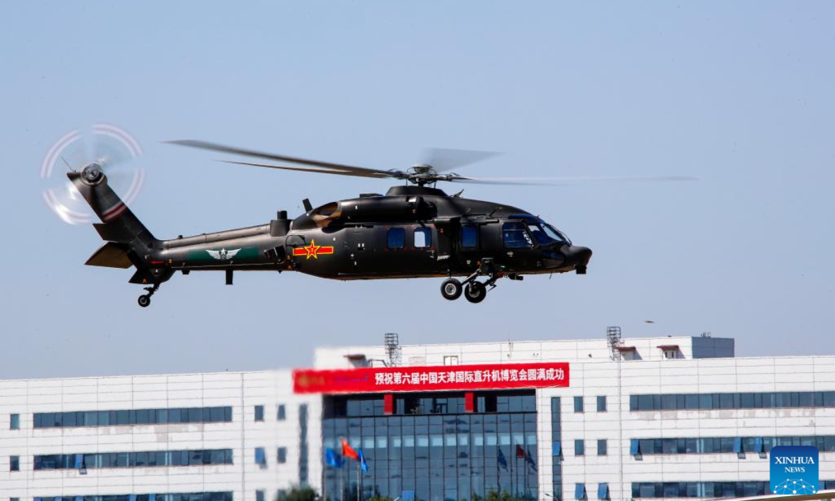 A helicopter of China's Fenglei aerobatic team is seen during a performance at the opening ceremony of the 6th China Helicopter Exposition in north China's Tianjin Municipality Sep 14, 2023. Photo:Xinhua