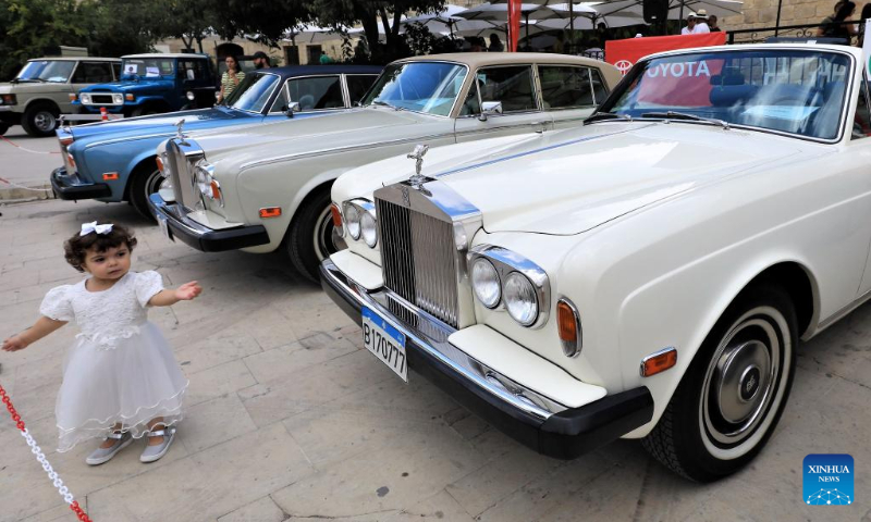 A girl is seen during a classic car show held in Deir el Qamar, Mount Lebanon Governorate, Lebanon, on Sept. 10, 2023. A classic car show was held Sunday in Deir el Qamar, a historic town in south-central Lebanon, featuring about 50 classic cars from different eras. (Xinhua/Liu Zongya)