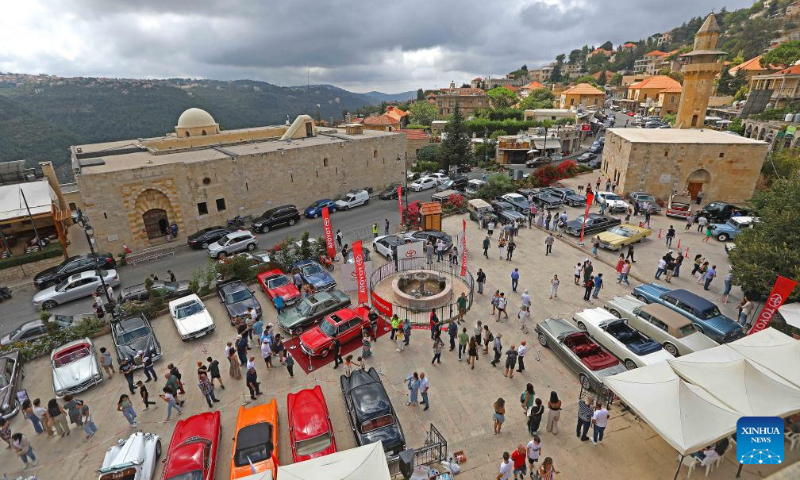 People visit a classic car show held in Deir el Qamar, Mount Lebanon Governorate, Lebanon, on Sept. 10, 2023. A classic car show was held Sunday in Deir el Qamar, a historic town in south-central Lebanon, featuring about 50 classic cars from different eras. (Xinhua/Bilal Jawich)