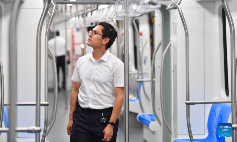 A guest from Mexico observes the interior of the first articulated light rail train customized by CRRC Zhuzhou Locomotive Co., Ltd. for Mexico City, in Zhuzhou, central China's Hunan Province, Sept. 9, 2023. The first articulated light rail train customized by CRRC Zhuzhou Locomotive Co., Ltd. for Mexico City has rolled off the assembly line on Saturday. (Xinhua/Chen Zeguo)