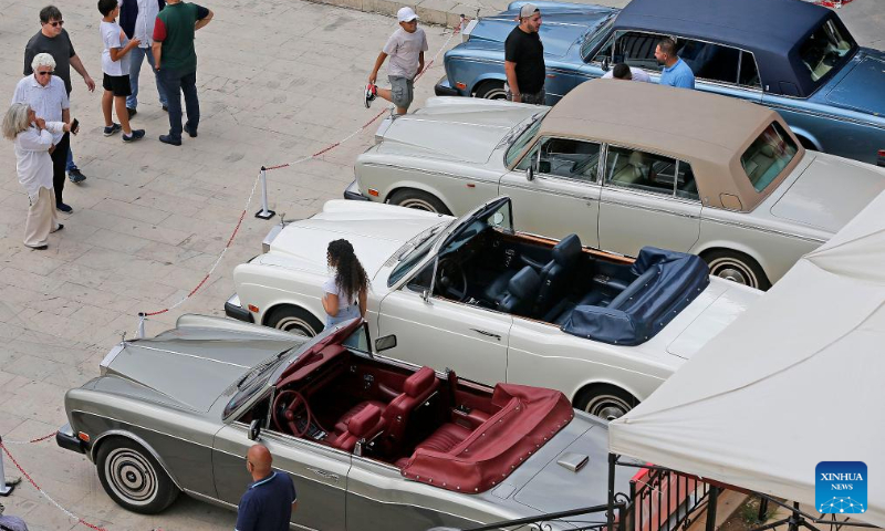 People visit a classic car show held in Deir el Qamar, Mount Lebanon Governorate, Lebanon, on Sept. 10, 2023. A classic car show was held Sunday in Deir el Qamar, a historic town in south-central Lebanon, featuring about 50 classic cars from different eras. (Xinhua/Bilal Jawich)