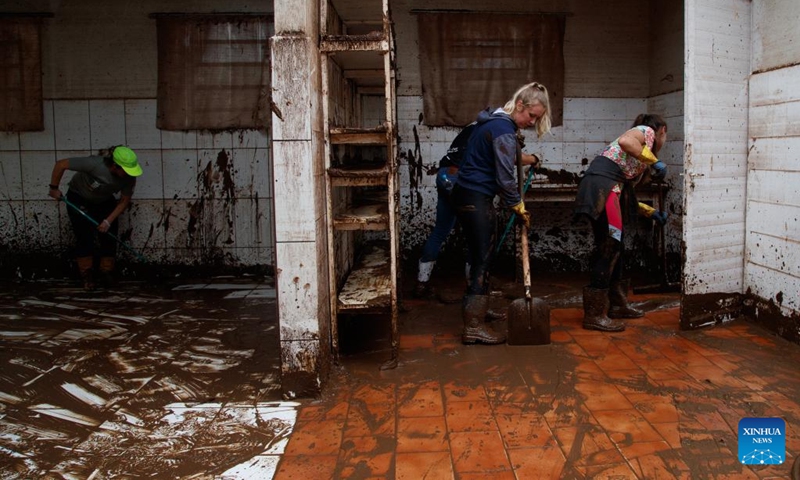 People clean up a building at the city of Mucum, Rio Grande do Sul, Brazil, on Sept. 9, 2023. Photo: Xinhua