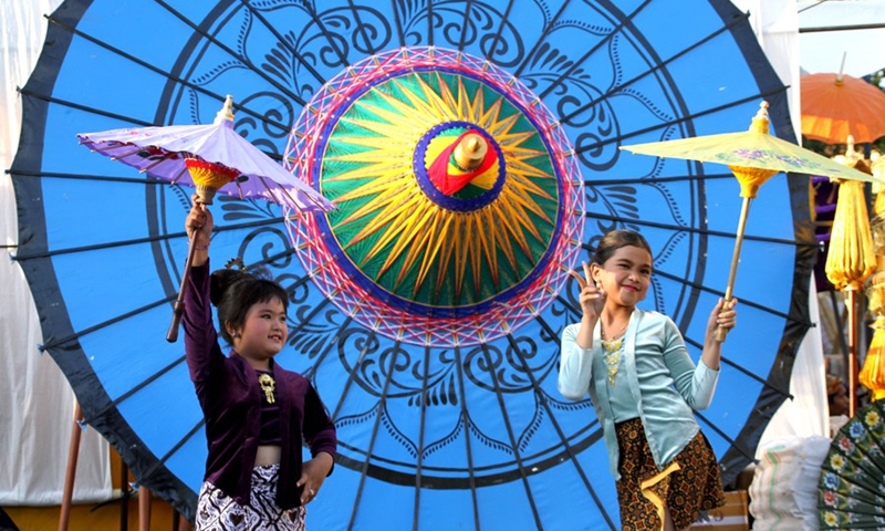 Children pose for photos with umbrellas during Indonesia Umbrella Festival 2023 in Surakarta, Central Java, Indonesia on Sept. 9, 2023. Photo: Xinhua