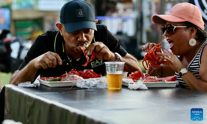 People taste lobsters during the Original Lobster Festival in Fountain Valley, California, the United States, on Sept. 8, 2023. Photo: Xinhua