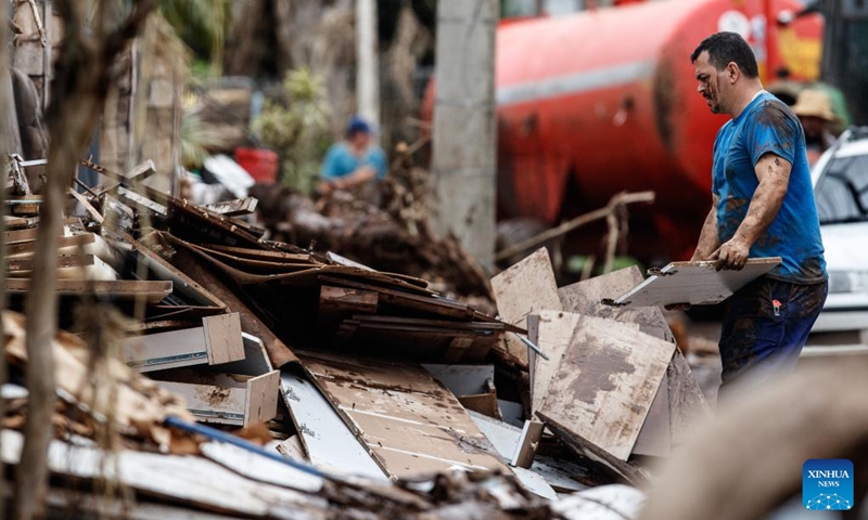 A man removes building debris on a street at the city of Mucum, Rio Grande do Sul, Brazil, on Sept. 9, 2023. Photo: Xinhua