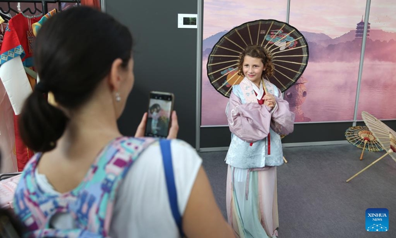 A young girl poses for photos in Hanfu costume while visiting the Chinese Pavilion at the Brussels Comic Strip Festival in Brussels, Belgium, on Sept. 8, 2023. The Chinese Pavilion opened its exhibition to the public on Friday during the Brussels Comic Strip Festival from Sept. 8 to 10. Photo: Xinhua