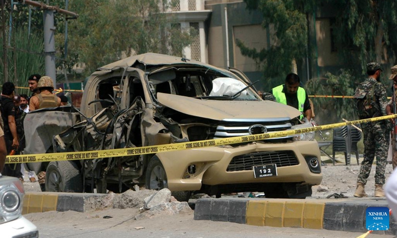 Security personnel examine a damaged vehicle at the explosion site in northwest Pakistan's Peshawar on Sept. 11, 2023. Seven security members and four civilians were injured when a bomb went off in Pakistan's northwest Khyber Pakhtunkhwa province on Monday, rescue teams and police said.(Photo: Xinhua)